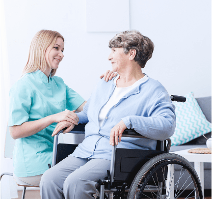 Nurse assisting elderly woman in wheelchair