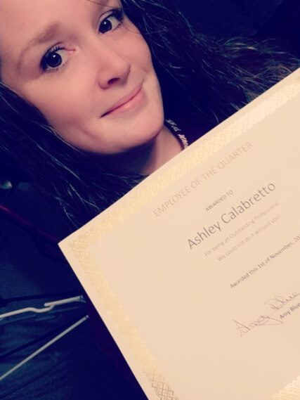 Person holding an award certificate