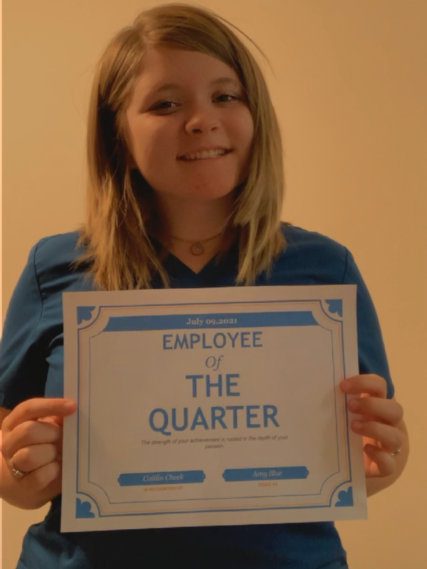 Smiling individual with achievement award