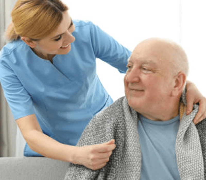 Nurse helping senior man at home