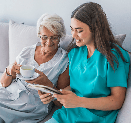 Elderly woman with caregiver on couch