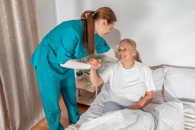 Caregiver helping senior patient