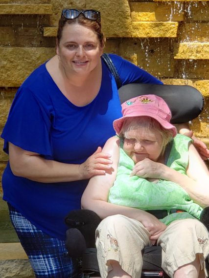 Woman with elderly person in wheelchair