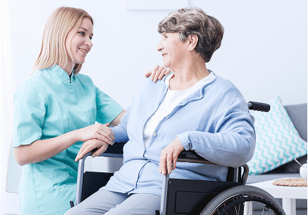 Nurse assisting elderly woman in wheelchair