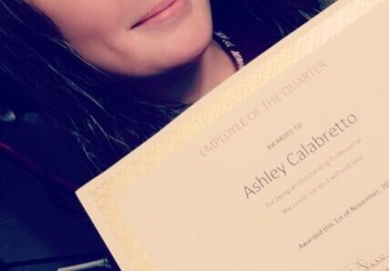 Person holding an award certificate