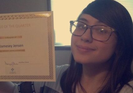 Proudly displaying an achievement certificate