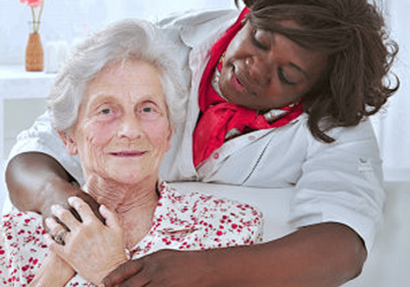 Nurse comforting senior patient