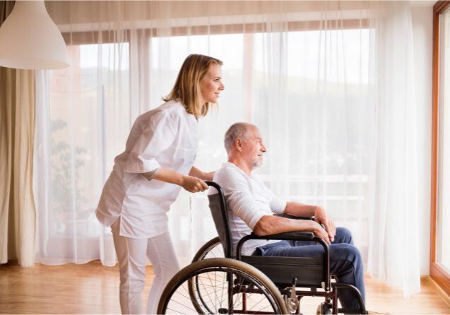 Supportive caregiver with senior near window