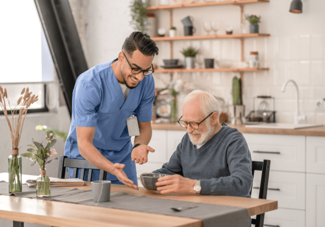 Healthcare worker and senior enjoying tea together